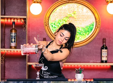 a women bartender making a cocktail