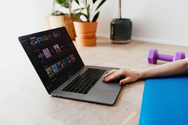 a women ready to workout using a laptop